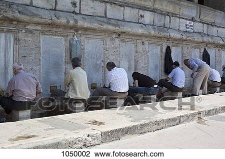 Muslim men wash their feet before praying in The New Mosque, Istanbul, Turkey View Large Photo Image Stock Image - Muslim men wash their feet before praying in The New Mosque, Istanbul, Turkey. Fotosearch