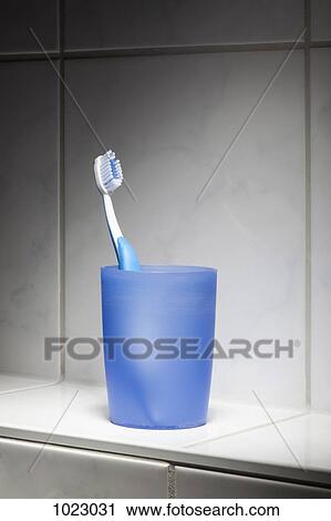 Stock Image - One toothbrush in a cup. Fotosearch