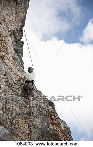 Person climbing rock face at The Wetterstein, Tirol, Austria, View Large Photo Image Stock Image - Person climbing rock face at The Wetterstein, Tirol, Austria,. Fotosearch