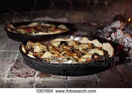 Pizzas cooking in a stone oven View Large Photo Image Picture - Pizzas cooking in a stone oven. Fotosearch
