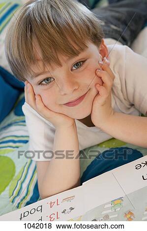 Stock Photo - Portrait of a boy with a book. Fotosearch