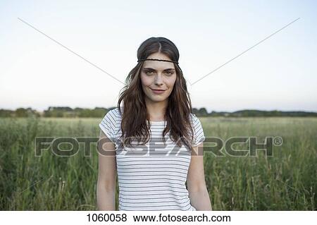 profile of girl with hair band standing in secluded field View Large Photo Image Stock Photo - profile of girl with hair band standing in secluded field. Fotosearch