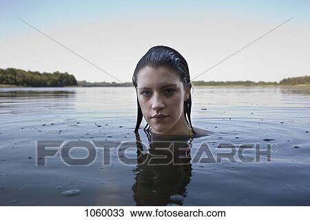 Profile of girl with head above water looking at camera View Large Photo Image Stock Image - Profile of girl with head above water looking at camera. Fotosearch