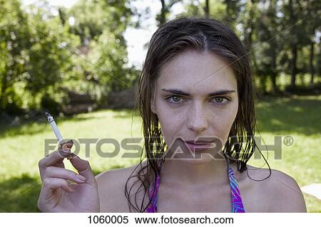 Stock Photography - Profile of girl with wet hair smoking. Fotosearch