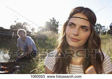 Profile of Long haired girl in field, and guy in the background looking at her View Large Photo Image Stock Image - Profile of Long haired girl in field, and guy in the background looking at her. Fotosearch