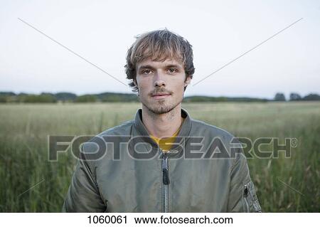 Profile of man standing in field View Large Photo Image Stock Image - Profile of man standing in field. Fotosearch