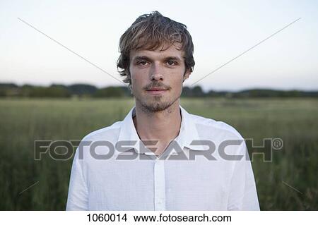 Profile of man standing in field with white shirt on View Large Photo Image Picture - Profile of man standing in field with white shirt on. Fotosearch