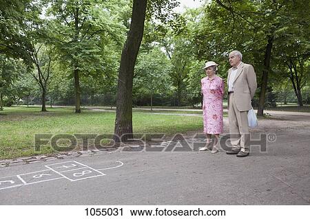 Senior couple contemplate hopscotch in the park View Large Photo Image Stock Image - Senior couple contemplate hopscotch in the park. Fotosearch