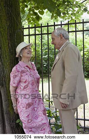 Picture - Senior couple make eye contact in park. Fotosearch