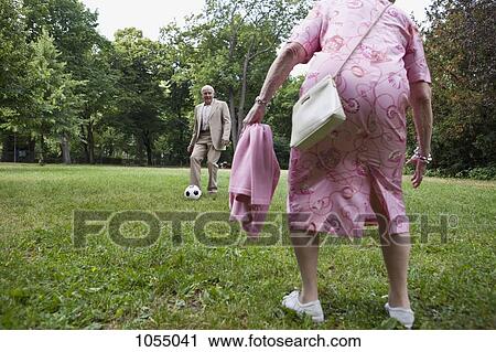 Senior couple play soccer in the park View Large Photo Image Stock Image - Senior couple play soccer in the park. Fotosearch
