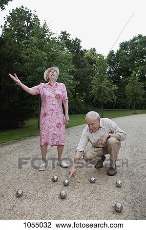 Senior man and woman have dispute playing boules in the park View Large Photo Image Stock Image - Senior man and woman have dispute playing boules in the park. Fotosearch