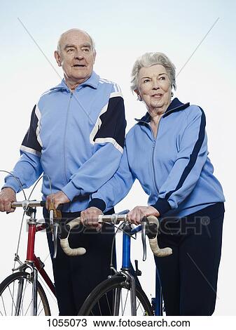 Senior man and woman holding racing bicycles View Large Photo Image Stock Image - Senior man and woman holding racing bicycles. Fotosearch