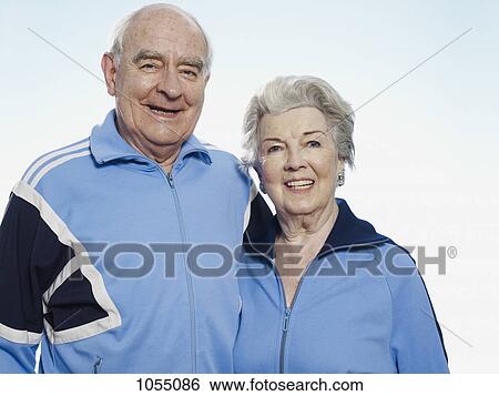 Senior man and woman in sportswear smiling at camera View Large Photo Image Stock Photograph - Senior man and woman in sportswear smiling at camera. Fotosearch