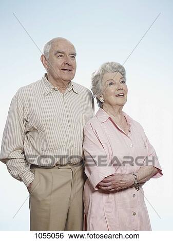 Senior man and woman side by side looking up View Large Photo Image Stock Photograph - Senior man and woman side by side looking up. Fotosearch