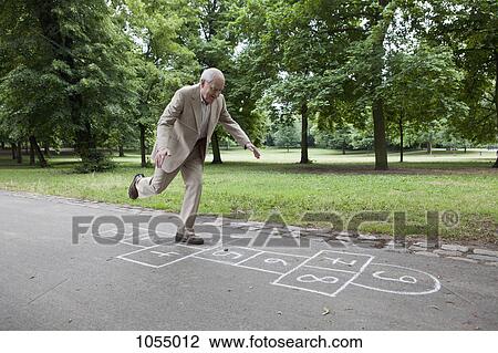 Senior man playing hopscotch in the park View Large Photo Image Stock Image - Senior man playing hopscotch in the park. Fotosearch