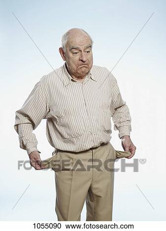 Senior man turns his pockets inside out to symbolize having no money View Large Photo Image Stock Image - Senior man turns his pockets inside out to symbolize having no money. Fotosearch