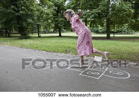 Senior woman playing hopscotch View Large Photo Image Stock Photo - Senior woman playing hopscotch. Fotosearch