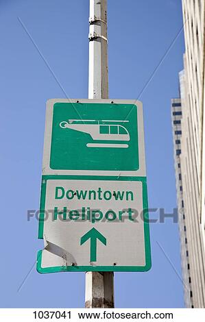Sign saying 'Downtown Heliport' with direction arrow View Large Photo Image Stock Image - Sign saying 'Downtown Heliport' with direction arrow. Fotosearch