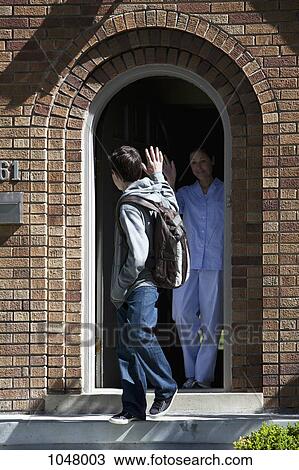 Son and Mother waving goodbye to each other at front door as son leaves house View Large Photo Image Stock Image - Son and Mother waving goodbye to each other at front door as son leaves house. Fotosearch