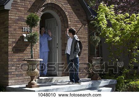 Son and Mother waving goodbye to each other at their front door as son leaves house View Large Photo Image Stock Image - Son and Mother waving goodbye to each other at their front door as son leaves house. Fotosearch