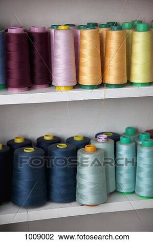 Spools of colored cotton thread on shelves View Large Photo Image Stock Image - Spools of colored cotton thread on shelves. Fotosearch