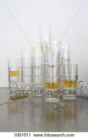 Stock Image - Stacks of beer glasses the morning after a party. Fotosearch