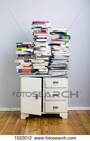 Stacks of books on a cabinet View Large Photo Image Stock Image - Stacks of books on a cabinet. Fotosearch