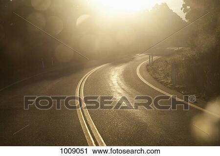 Sunlight over a curve in a highway road View Large Photo Image Stock Image - Sunlight over a curve in a highway road. Fotosearch