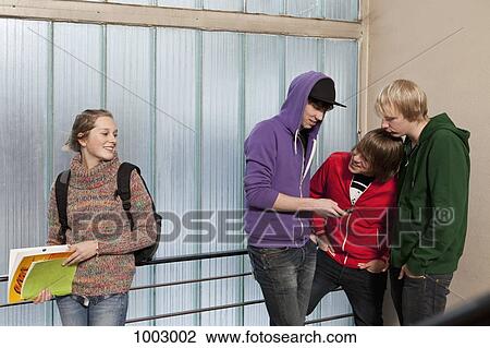 Stock Image - Teenagers hanging out in a school stairwell. Fotosearch