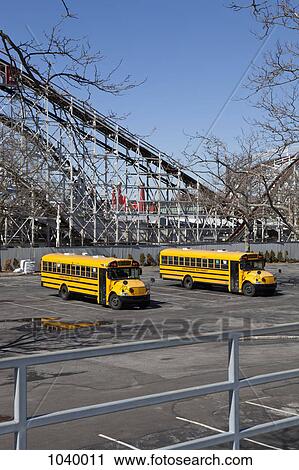 Two empty school buses in an abandoned parking lot, Coney Island, USA View Large Photo Image Stock Image - Two empty school buses in an abandoned parking lot, Coney Island, USA. Fotosearch