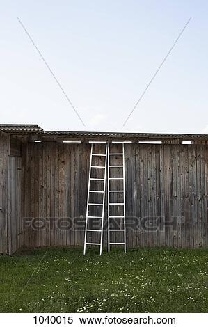 Two ladders leaning against a rustic wooden structure View Large Photo Image Stock Photography - Two ladders leaning against a rustic wooden structure. Fotosearch