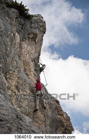 Two people climbing rock face at The Wetterstein, Tirol, Austria, View Large Photo Image Stock Image - Two people climbing rock face at The Wetterstein, Tirol, Austria,. Fotosearch