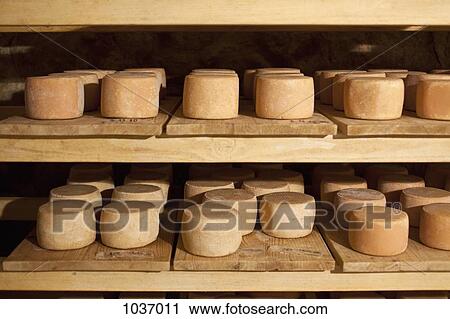 Two shelves of cheese wheels View Large Photo Image Stock Image - Two shelves of cheese wheels. Fotosearch