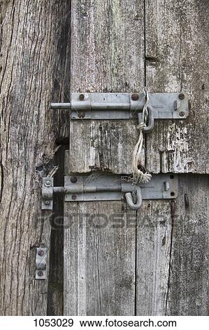 Two slide latches on a warped wooden door View Large Photo Image Stock Photo - Two slide latches on a warped wooden door. Fotosearch