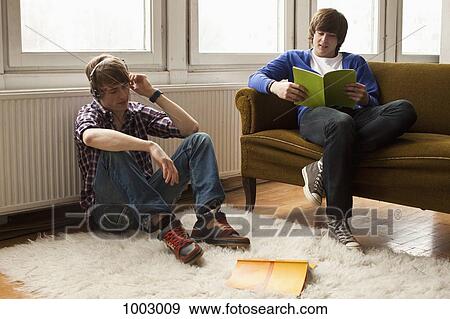 Two teenage boys hanging out in a living room View Large Photo Image Stock Photo - Two teenage boys hanging out in a living room. Fotosearch