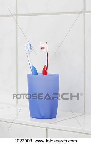 Two toothbrushes in a cup View Large Photo Image Stock Photo - Two toothbrushes in a cup. Fotosearch