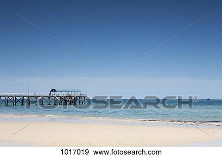 View of a pier from a sandy beach View Large Photo Image Stock Photo - View of a pier from a sandy beach. Fotosearch