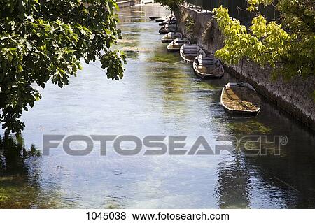 View of a river flowing through a village View Large Photo Image Stock Photo - View of a river flowing through a village. Fotosearch
