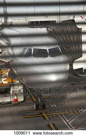 View through a window of an airplane connected to a passenger boarding bridge View Large Photo Image Stock Image - View through a window of an airplane connected to a passenger boarding bridge. Fotosearch