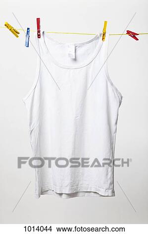 White tank top hanging on clothes line View Large Photo Image Picture - White tank top hanging on clothes line. Fotosearch