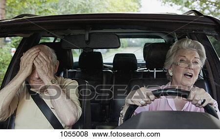 Woman has trouble driving while man in passenger seat despairs View Large Photo Image Stock Photo - Woman has trouble driving while man in passenger seat despairs. Fotosearch