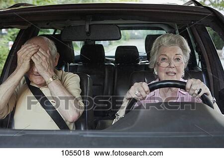 Woman has trouble driving while man in passenger seat despairs View Large Photo Image Stock Photo - Woman has trouble driving while man in passenger seat despairs. Fotosearch