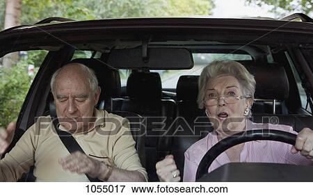 Woman learning to drive gets excited while man in passenger seat appeals for calm View Large Photo Image Stock Photo - Woman learning to drive gets excited while man in passenger seat appeals for calm. Fotosearch