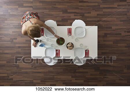 Woman setting dining room table for dinner party, overhead view View Large Photo Image Stock Image - Woman setting dining room table for dinner party, overhead view. Fotosearch