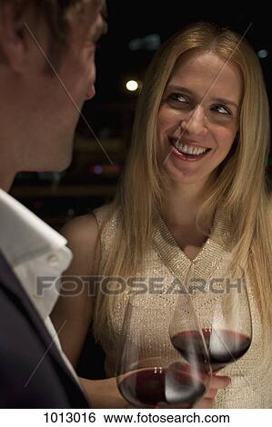 Woman smiles admiringly as a toast is made. View Large Photo Image Stock Photograph - Woman smiles admiringly as a toast is made.. Fotosearch