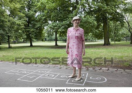 Woman standing on hopscotch markings View Large Photo Image Stock Image - Woman standing on hopscotch markings. Fotosearch