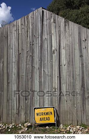 Workmen Ahead sign leaning against a wood building View Large Photo Image Stock Image - Workmen Ahead sign leaning against a wood building. Fotosearch