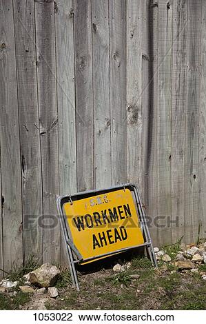 Workmen Ahead sign leaning against a wood building View Large Photo Image Stock Image - Workmen Ahead sign leaning against a wood building. Fotosearch