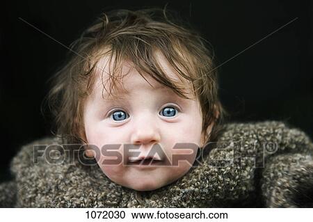 Stock Image - A baby in a warm sweater. Fotosearch