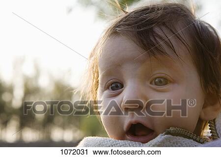 Stock Image - A baby staring into the camera. Fotosearch